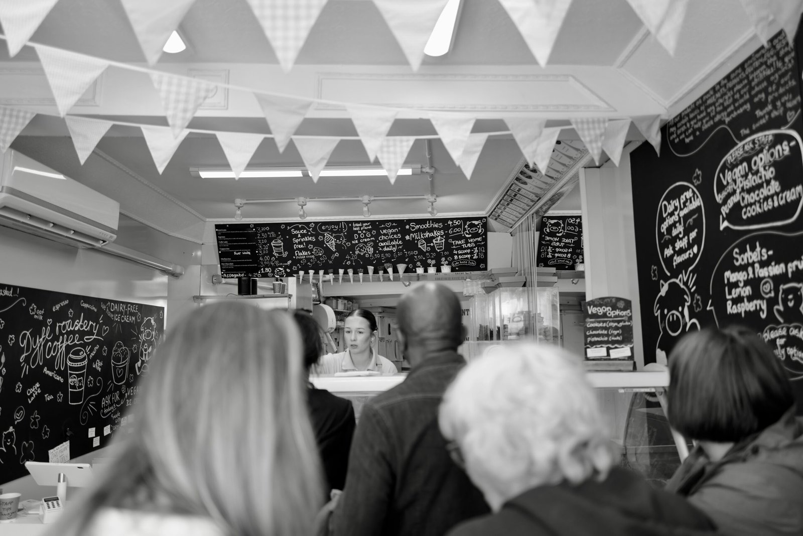 A black and white photo of people in a restaurant